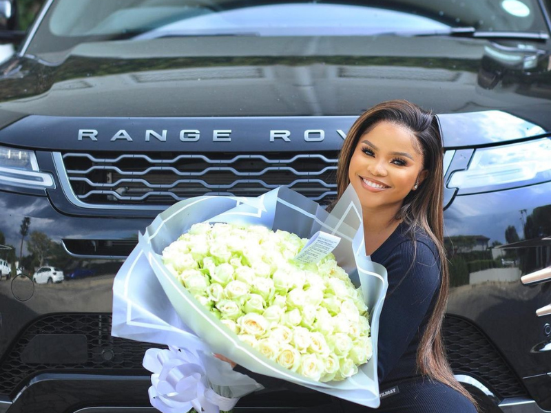 Khanya Mkangisa holding a bouquet of white roses