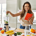 woman preparing a smoothie in a kitchen