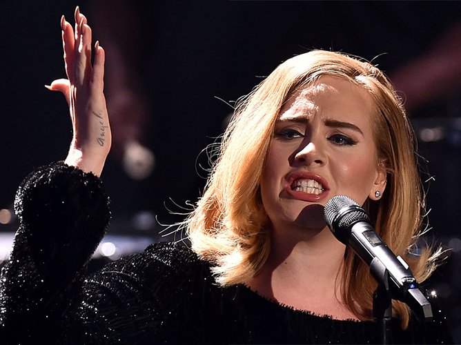 Adele raises her hand like a diva