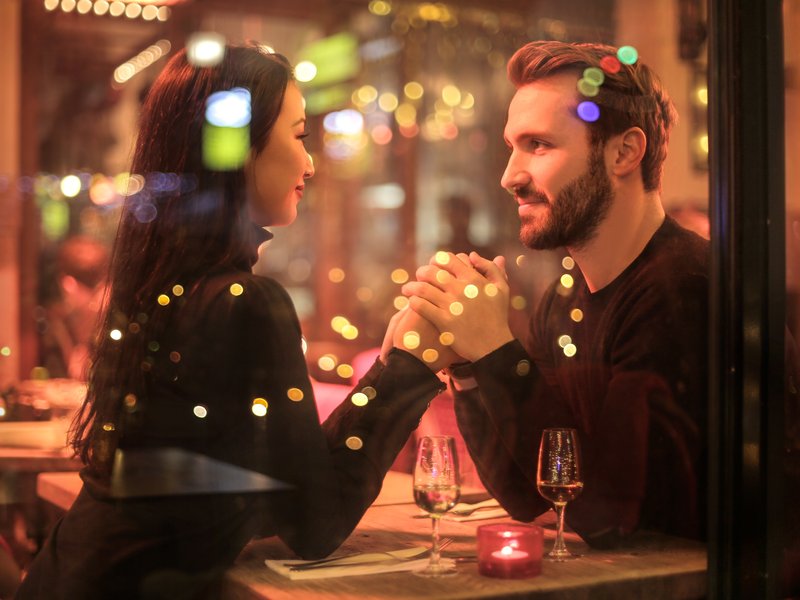 couple on a date hold hands
