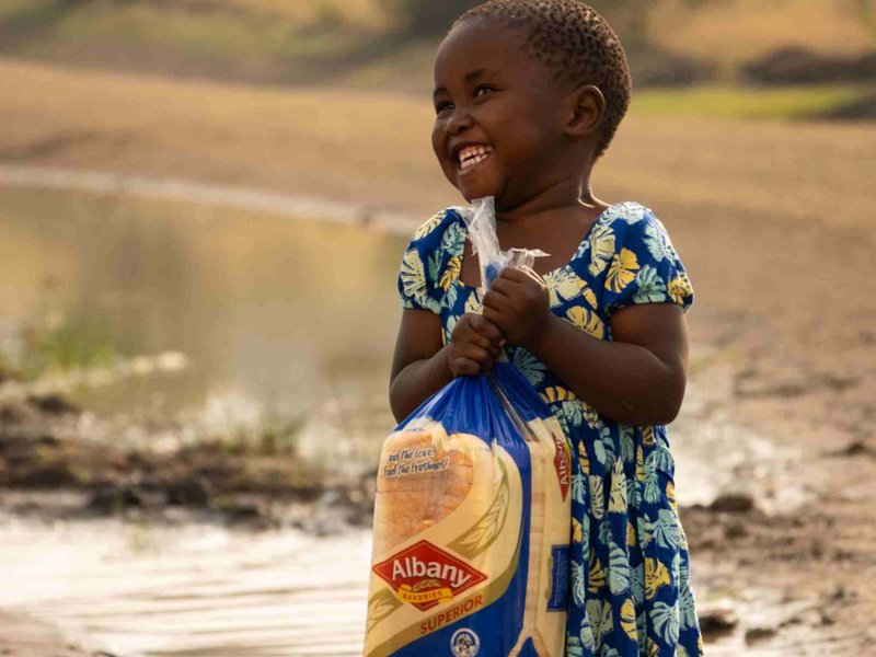 Breathtaking picture of girl holding loaf of bread