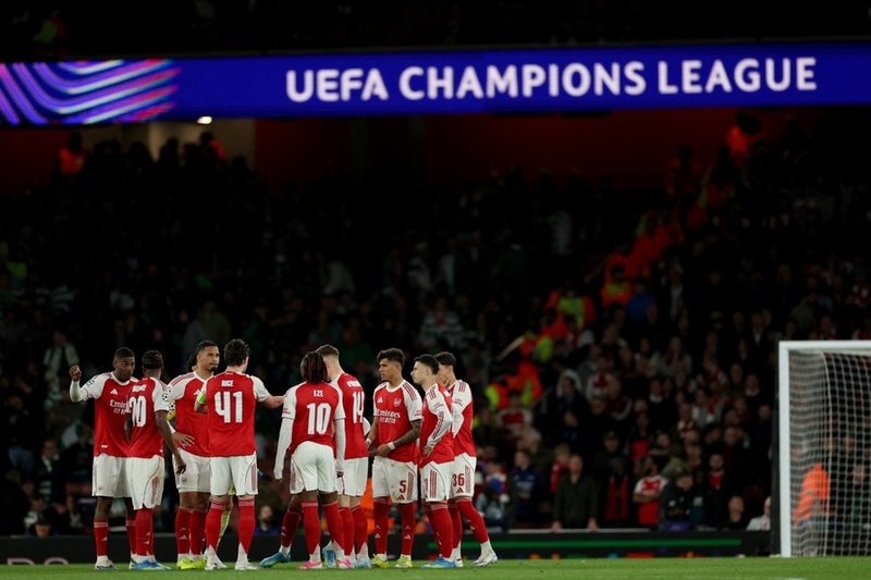 Arsenal players celebrate a goal in Champions League