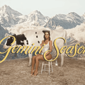 bianca censori sits on a stool in front of a cow