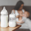 Two bottles of breastmilk on a wooden table