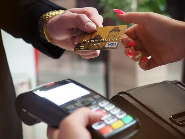 a man handing over card to woman