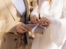 bride and groom opening a wedding gift.png