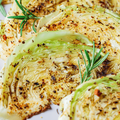 cabbage steaks with spices on grey plate