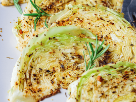 cabbage steaks with spices on grey plate