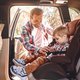 Father putting child in car seat