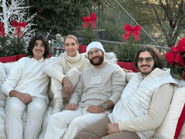 Celine Dion and her sons sitting on an outdoor couch