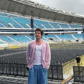 Charlie Puth standing on a stadium stage during soundcheck