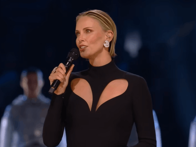Charlize Theron wearing a black Versace gown