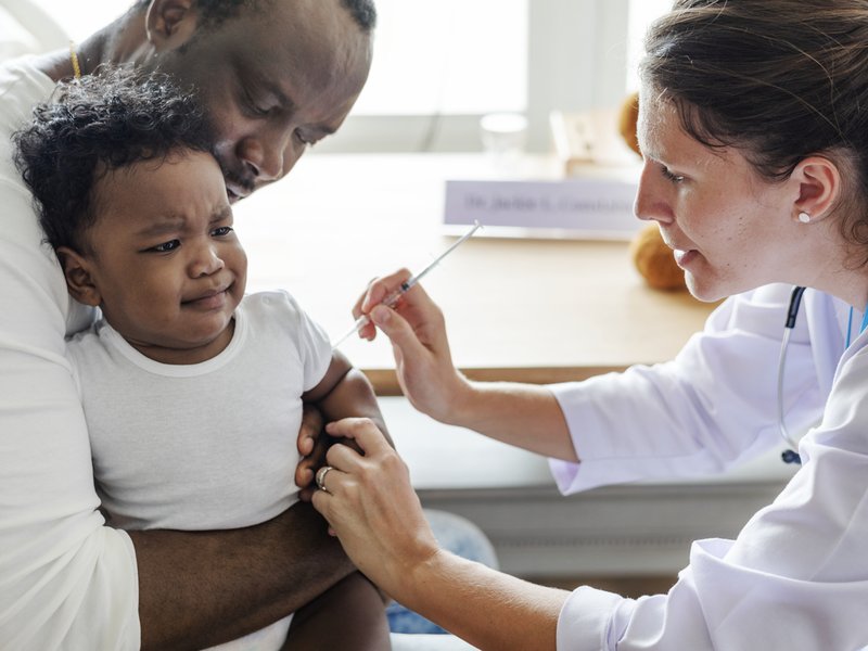 Baby getting a first vaccination injection