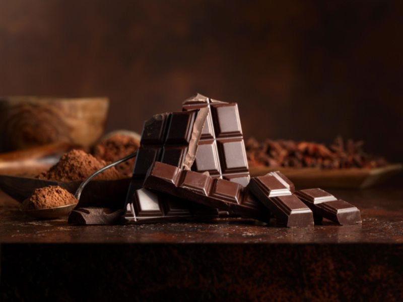 chocolate on brown table with cocoa powder