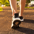 Close up of woman's running shoes on a footpath