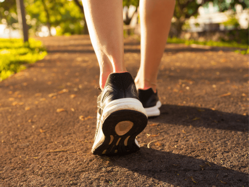Close up of woman's running shoes on a footpath