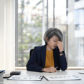 Woman looking stressed and overworked in an office