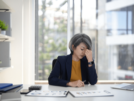 Woman looking stressed and overworked in an office