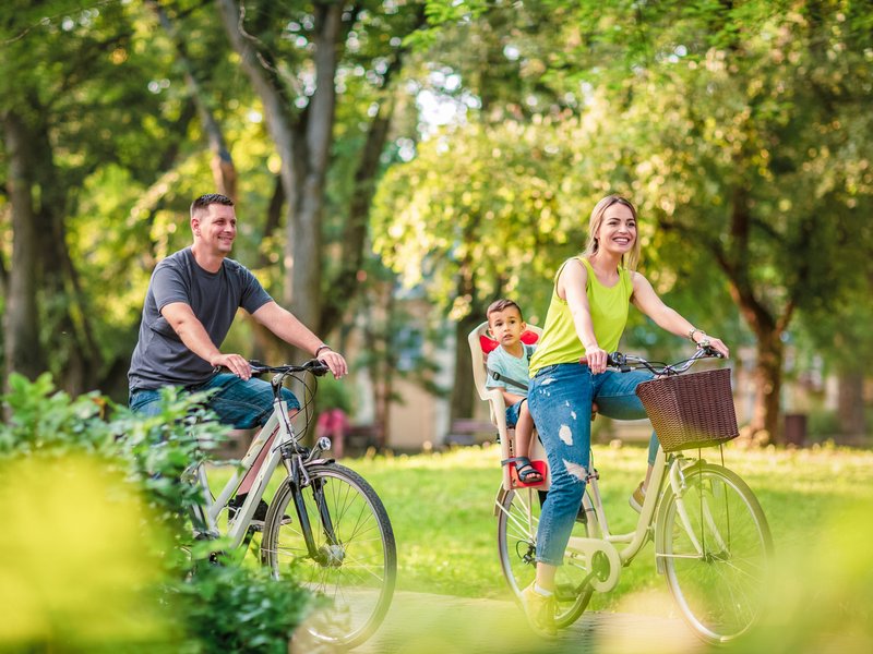 Father and mother with kid on bicycles