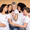 Diverse women wearing white t-shirts and pink ribbons