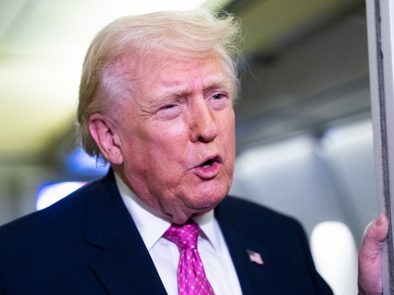 US President Donald Trump addresses media on board Airforce One
