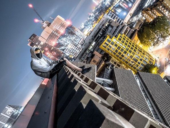 guy climbs building in London