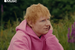 Ed sheeran wearing a pink hoodie with a Play icon