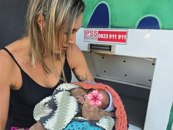 Baby savers rescuing a baby from a baby box