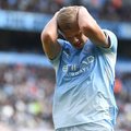 Manchester City striker Erling Haaland head in hands