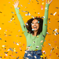 excited woman celebrating is showered in confetti