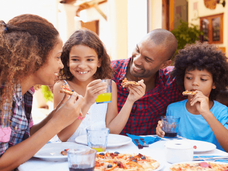 Family eating pizza at a restaurant