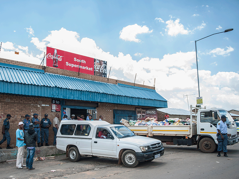 Police keep watch outside a foreign-owned shop