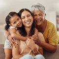 grandmother mother and young daughter embrace