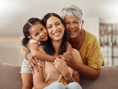 grandmother mother and young daughter embrace