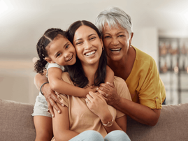grandmother mother and young daughter embrace