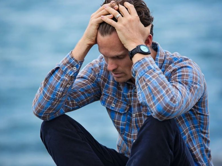 A man with his hands on his head