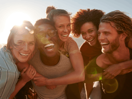 group of friends have fun piggybacking at the roadside