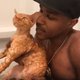 Guy bathing with cat