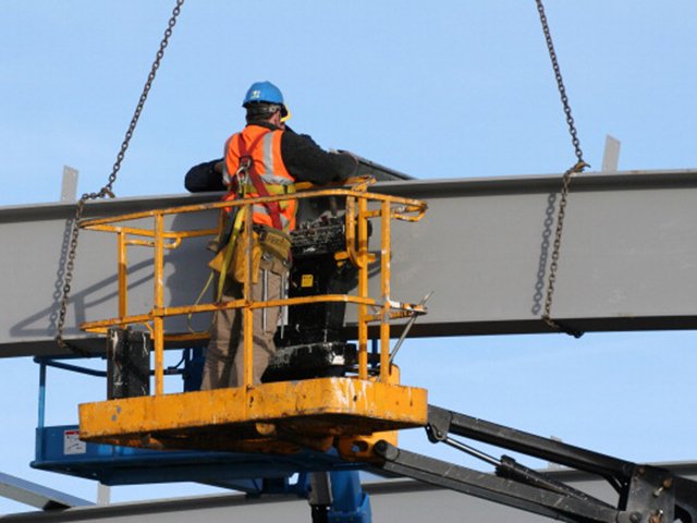 A man on a hydraulic lift