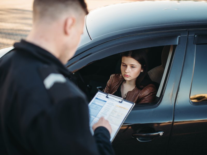 Traffic officer stopping motorists who don't have valid licenses