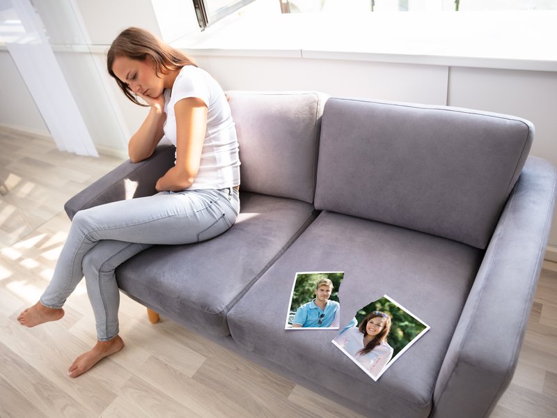 Lonely Woman Sitting On Sofa