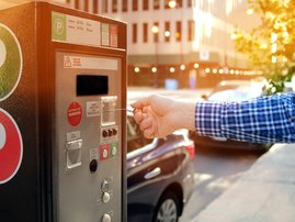 Man is paying his parking using credit card at parking pay station terminal