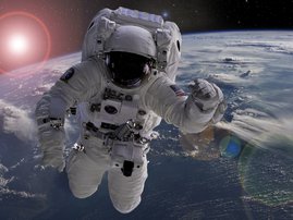 Astronaut flying in outer space near planet earth doing some work near space ship, elements of this image were taken from NASA photos