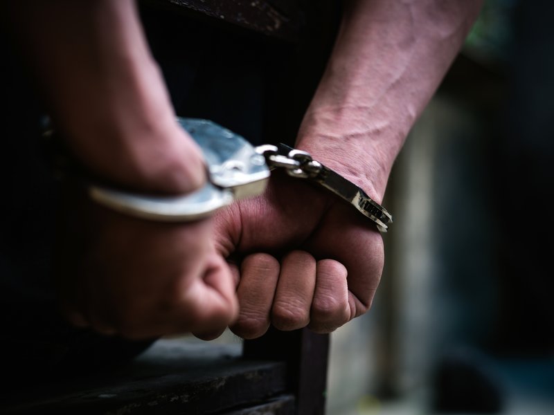 Man with handcuffs sitting on the chair