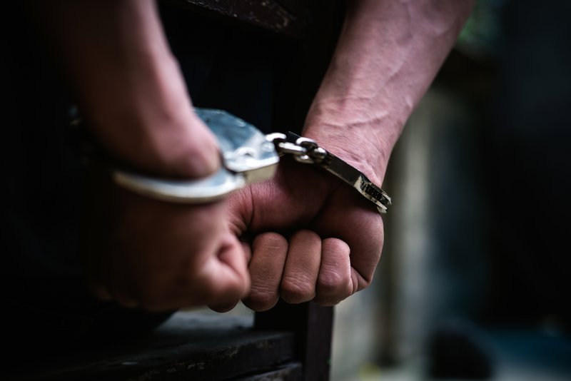 Man with handcuffs sitting on the chair