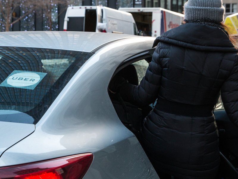 Lady getting into an Uber / iStock
