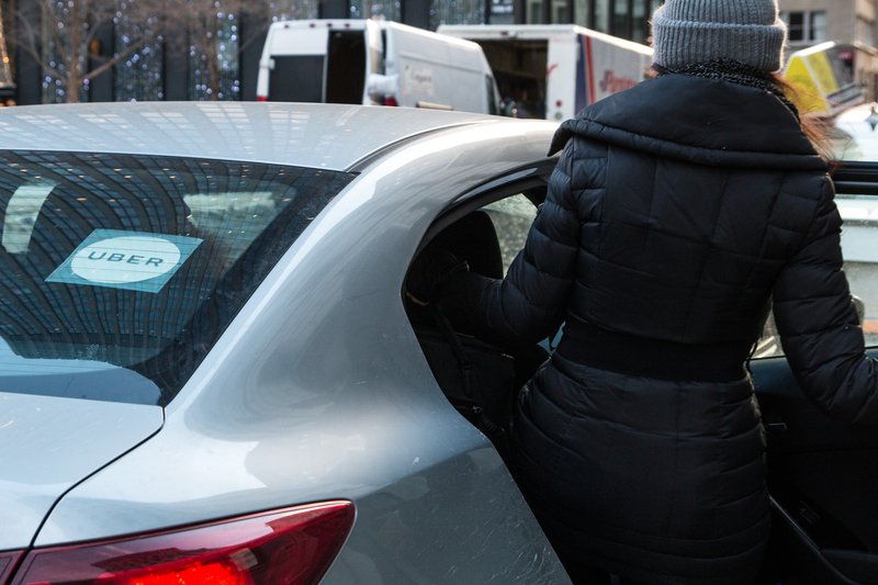 Lady getting into an Uber / iStock