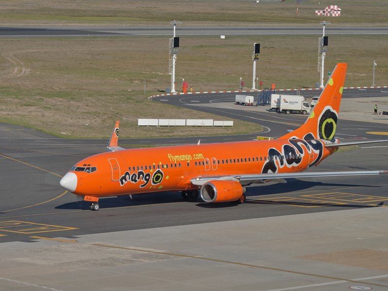 Mango airlines plane taxi on runway. stock photo