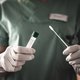 Nurse holds a swab for the coronavirus / covid19 test stock photo