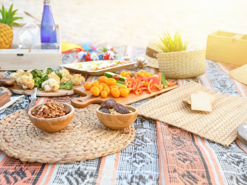 Beautiful summer picnic on the beach at sunset in zero waste style. Eco friendly idea for weekend staycations stock photo